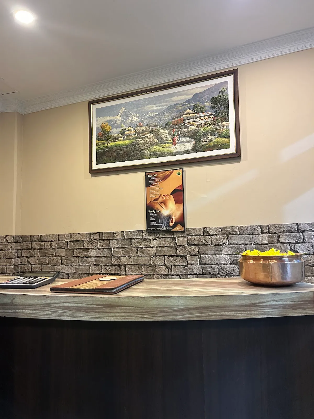 Reception with a Himalayan painting and brass bowl of marigold petals