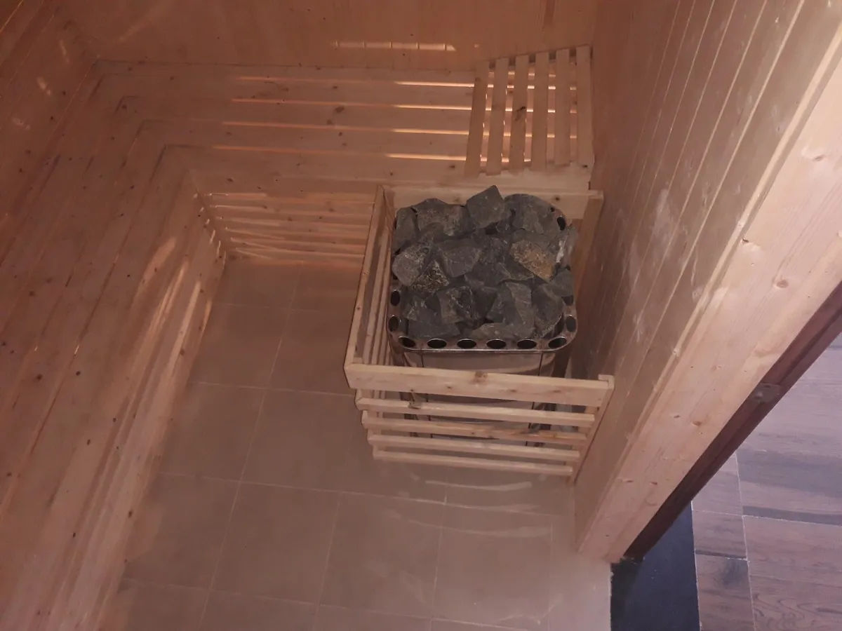 Cedar-lined sauna with stone heater